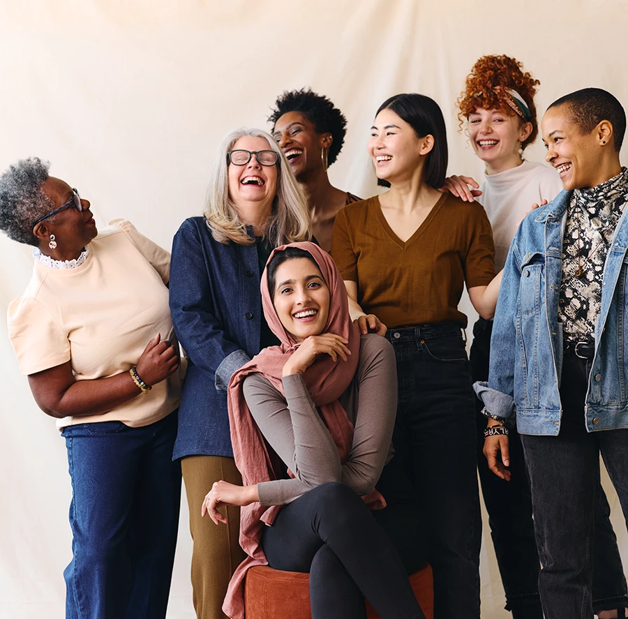 a diverse group of women posing for a photo shoot.